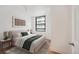 Serene bedroom with a comfortable bed, natural light, and a calming color palette at 444 17Th St # 802, Denver, CO 80202