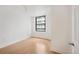 An empty room with wooden floors and a large window at 444 17Th St # 802, Denver, CO 80202