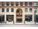 Historic building facade with large windows and decorative stone entrance at 444 17Th St # 802, Denver, CO 80202