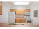 Bright kitchen features wood cabinets, white appliances, and lots of counter space at 444 17Th St # 802, Denver, CO 80202