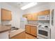 Bright kitchen features wood cabinets, white appliances, and lots of counter space at 444 17Th St # 802, Denver, CO 80202