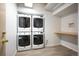 Laundry room featuring stacked washer/dryer units and a wooden shelf for added convenience at 444 17Th St # 802, Denver, CO 80202