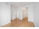 An empty room with wooden floors, three doors, and two closets at 444 17Th St # 802, Denver, CO 80202