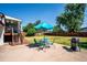 Spacious backyard with a patio, outdoor dining set and mature shade trees at 5945 W Colgate Pl, Denver, CO 80227
