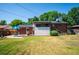 The backyard showcases a grassy lawn, a brick exterior, and outdoor dining for warm weather gatherings at 5945 W Colgate Pl, Denver, CO 80227
