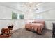 Basement bedroom with carpet and two windows plus a charming decorative rocking horse at 5945 W Colgate Pl, Denver, CO 80227