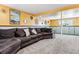 Finished basement with a large sectional and gray carpet; plenty of room for entertaining at 5945 W Colgate Pl, Denver, CO 80227