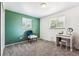 Bedroom with a teal accent wall, chair and desk with lots of light from the windows at 5945 W Colgate Pl, Denver, CO 80227