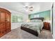 Comfortable bedroom with a large bed, carpet, an armoire, and natural light from the window at 5945 W Colgate Pl, Denver, CO 80227