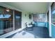 A covered and enclosed porch offers a relaxing sitting area with outdoor views at 5945 W Colgate Pl, Denver, CO 80227