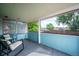The enclosed porch with windows offers a relaxing sitting area with views of the backyard and neighborhood at 5945 W Colgate Pl, Denver, CO 80227