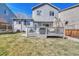 The back of the home featuring a small deck with a BBQ, and well maintained lawn at 9851 Castle Ridge Cir, Highlands Ranch, CO 80129