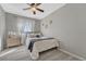Well-lit bedroom with neutral tones, ceiling fan, and modern decor at 9851 Castle Ridge Cir, Highlands Ranch, CO 80129