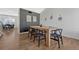 Bright dining room featuring modern decor, a wood table and hardwood flooring at 9851 Castle Ridge Cir, Highlands Ranch, CO 80129