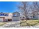 Inviting two-story home with a well-manicured front lawn, a gray siding and an attached garage at 9851 Castle Ridge Cir, Highlands Ranch, CO 80129