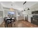 Modern kitchen and dining area with stainless steel appliances, white cabinets, and hardwood floors at 9851 Castle Ridge Cir, Highlands Ranch, CO 80129