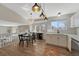 Bright, open kitchen area with stainless steel appliances, stylish lighting, and an adjacent dining space at 9851 Castle Ridge Cir, Highlands Ranch, CO 80129