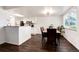 Well-lit dining area adjacent to a modern kitchen featuring stainless appliances at 1825 S Pitkin Cir # 10, Aurora, CO 80017