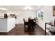 Dining room with a wooden table, dark wood floors, and a bright window at 1825 S Pitkin Cir # 10, Aurora, CO 80017