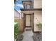 Front entrance of a tan home with a dark trim, a welcome mat, and an outdoor light at 1825 S Pitkin Cir # 10, Aurora, CO 80017
