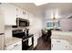 Bright kitchen features white cabinets, granite countertops, and stainless steel appliances at 1825 S Pitkin Cir # 10, Aurora, CO 80017