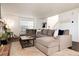 Comfortable living area featuring a sectional sofa, a cozy rug, and access to a staircase at 1825 S Pitkin Cir # 10, Aurora, CO 80017