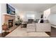 Inviting living room features a brick fireplace, hardwood floors, and a comfortable gray sectional sofa at 1825 S Pitkin Cir # 10, Aurora, CO 80017