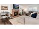 Warm living room with a cozy fireplace, complemented by stylish decor and a comfortable sectional sofa at 1825 S Pitkin Cir # 10, Aurora, CO 80017