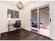 Well-lit home office with wood-look floors and sliding doors leading to the outside at 1825 S Pitkin Cir # 10, Aurora, CO 80017