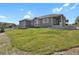 Spacious backyard offering a covered patio and well-maintained lawn at 5723 Berry Ridge Way, Castle Rock, CO 80104