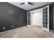 Dark gray bedroom featuring neutral carpeting and double doors at 5723 Berry Ridge Way, Castle Rock, CO 80104