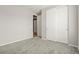 Bright bedroom featuring neutral carpeting and white closet doors at 5723 Berry Ridge Way, Castle Rock, CO 80104