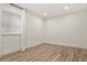 Bright bedroom featuring laminate flooring and window with blinds at 5723 Berry Ridge Way, Castle Rock, CO 80104