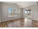 Bright dining room with wood floors, stylish light fixture, and sliding glass door to outside at 5723 Berry Ridge Way, Castle Rock, CO 80104
