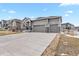 Beautiful house with a three-car garage, and well-maintained lawn at 5723 Berry Ridge Way, Castle Rock, CO 80104
