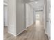Long hallway with wood floors and white doors leads to a bright, inviting space at 5723 Berry Ridge Way, Castle Rock, CO 80104