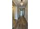 Hallway with wood floors, neutral walls and a stylish chandelier offers a welcoming space with ample natural light at 5723 Berry Ridge Way, Castle Rock, CO 80104