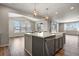 Kitchen island with white countertops and sink, pendant lights and hardwood flooring at 5723 Berry Ridge Way, Castle Rock, CO 80104