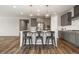 Modern kitchen features gray cabinets, stainless steel appliances, and a spacious island with seating at 5723 Berry Ridge Way, Castle Rock, CO 80104