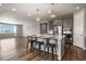 Modern kitchen with bar seating island, stainless steel appliances, and view to living area at 5723 Berry Ridge Way, Castle Rock, CO 80104