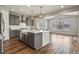 Bright kitchen featuring a large island, modern appliances, and elegant pendant lighting at 5723 Berry Ridge Way, Castle Rock, CO 80104