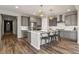 Modern kitchen with stainless steel appliances, tile backsplash, and a spacious island at 5723 Berry Ridge Way, Castle Rock, CO 80104