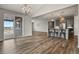 Open-concept space featuring wood floors, access to the patio, and view to the kitchen with bar seating at 5723 Berry Ridge Way, Castle Rock, CO 80104