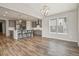 Open-concept area with vaulted ceilings, wood floors, and view of the kitchen with bar seating at 5723 Berry Ridge Way, Castle Rock, CO 80104