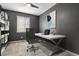 Home office with a modern desk, stylish decor, and ample natural light from a large window at 5723 Berry Ridge Way, Castle Rock, CO 80104