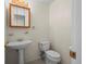 Cozy half bathroom featuring pedestal sink, toilet, and classic mirror with lighting at 3631 W 79Th Ave # A2, Westminster, CO 80030