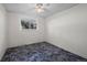 A cozy bedroom with a ceiling fan, neutral walls, carpet, and a window overlooking the exterior of the property at 3631 W 79Th Ave # A2, Westminster, CO 80030