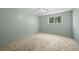 This bedroom offers a ceiling fan, neutral carpet, and a window overlooking the yard at 3631 W 79Th Ave # A2, Westminster, CO 80030