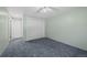 A comfortable bedroom with a ceiling fan, closet, and carpet, adjacent to a hallway with doors at 3631 W 79Th Ave # A2, Westminster, CO 80030