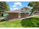 Back exterior of brick home featuring a carport, small yard, and stairs to the second story at 3631 W 79Th Ave # A2, Westminster, CO 80030
